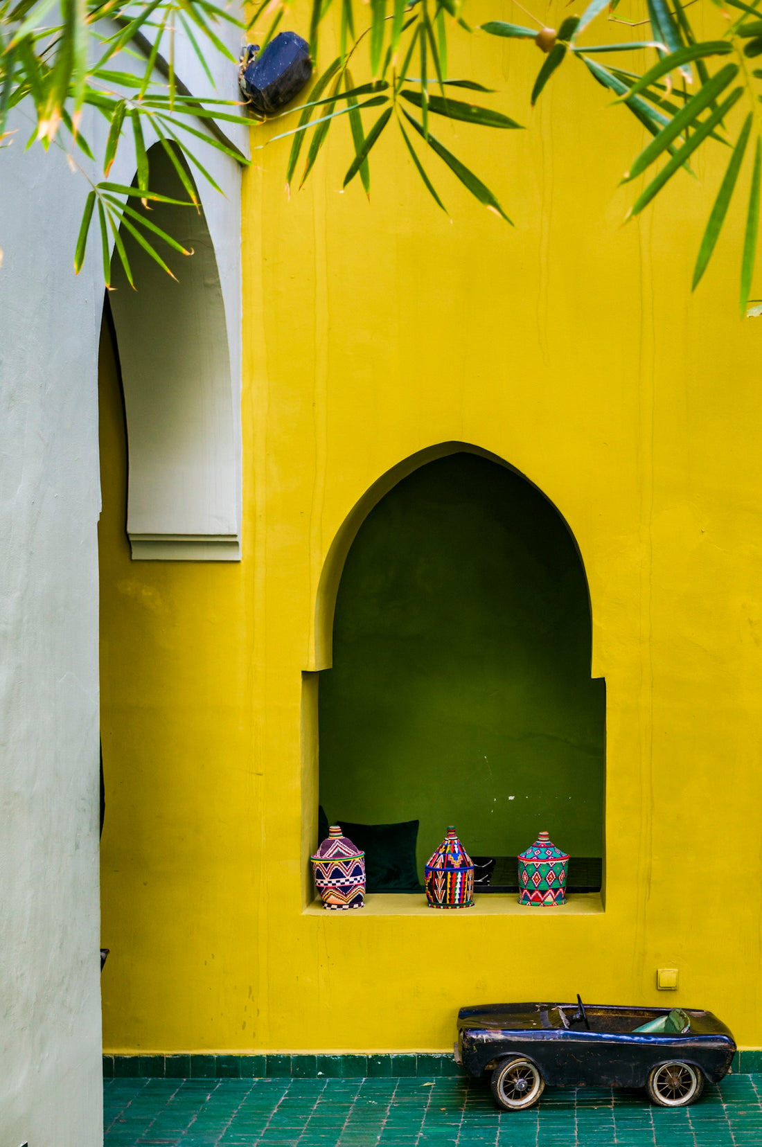 a toy car sitting in front of a yellow wall
