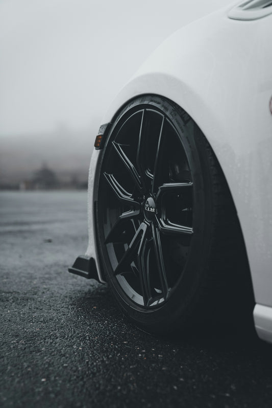 White car with black rim in foggy weather.